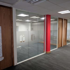 double glazed frameless glass partition with white track and full height oak doors in Hereford