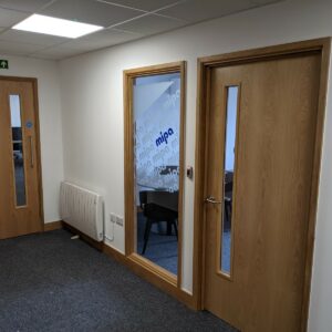 oak veneer doors set into oak linings, oak windows and skirtings in an office in Hereford