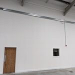 Fire rated drywall partition in an industrial unit