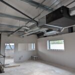 Wall lining and metal stud partition in an office.