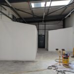 Corner office and toilet in an industrial unit.